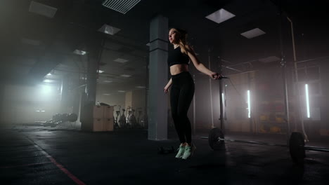 Slow-motion:-Young-woman-skipping-rope.-woman-jump-roping-in-the-gym-as-part-of-her-workout-routine-determined-woman-focused